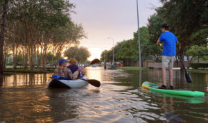 People on kayak's in flooded streets following a hurricane
